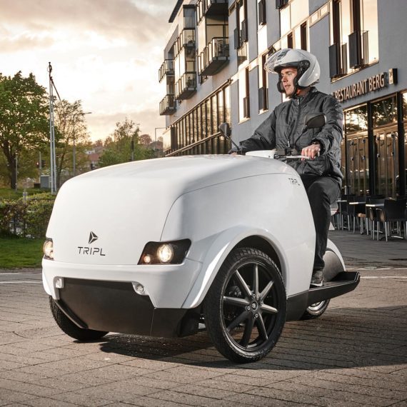 a man driving Tripl Electric cargo scooter