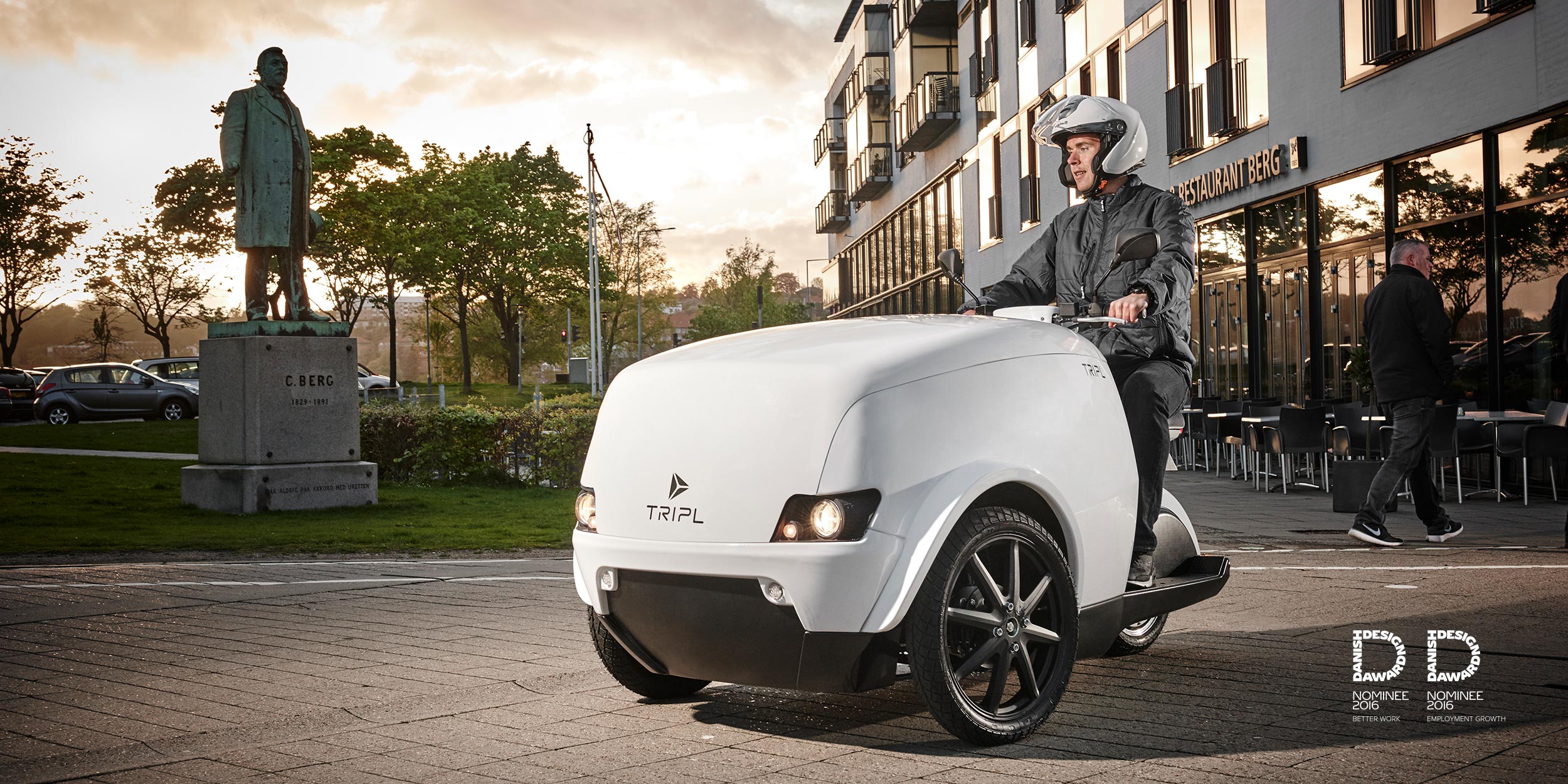 a man driving Tripl Electric cargo scooter