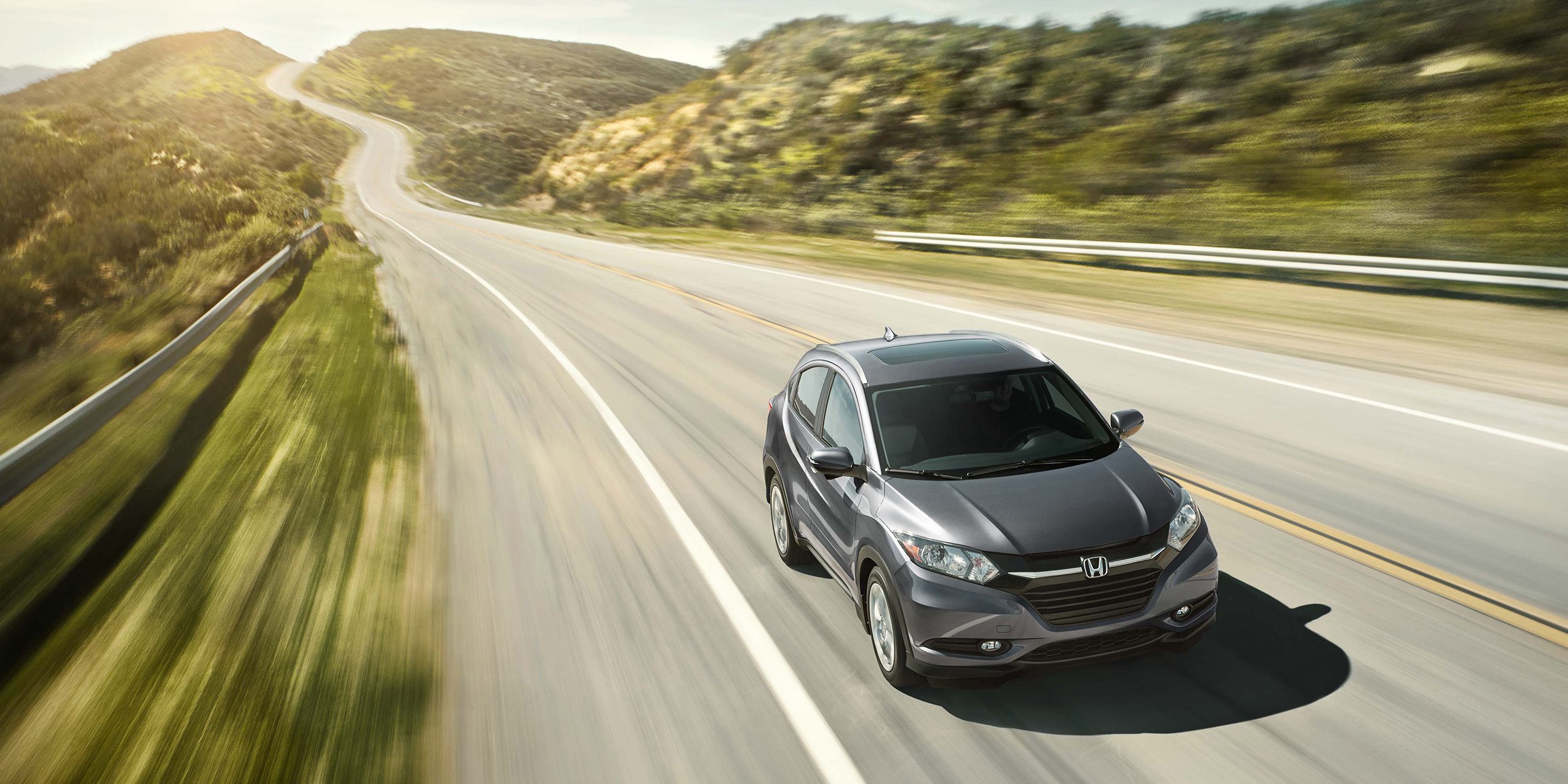 Honda car driving on the road