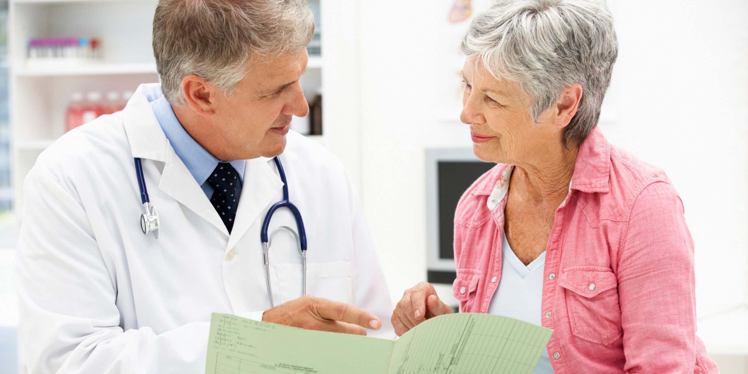 A doctor talking to an old lady at the hospital